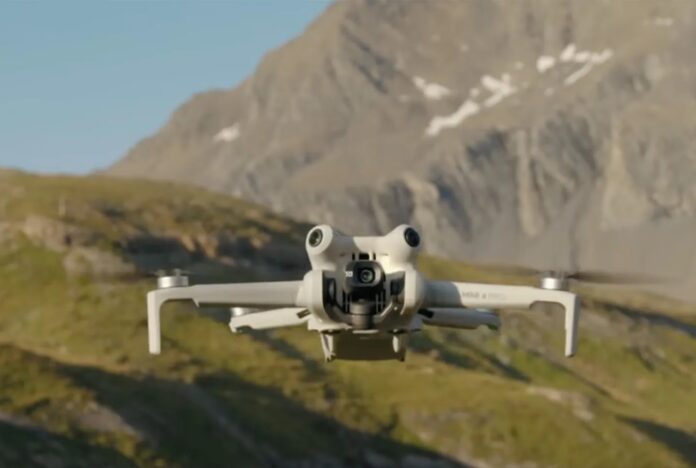 โดรน DJI Mini 4 Pro กำลังบินท่ามกลางฉากหลังของภูเขาและธรรมชาติ
