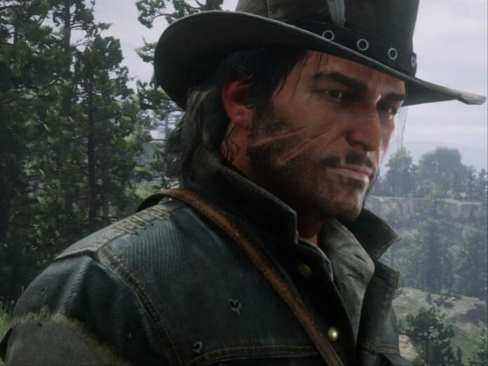 John Marston จากเกม Red Dead Redemption 2 สวมหมวกคาวบอยและเสื้อแจ็กเก็ตยีนส์ ยืนอยู่กลางป่า