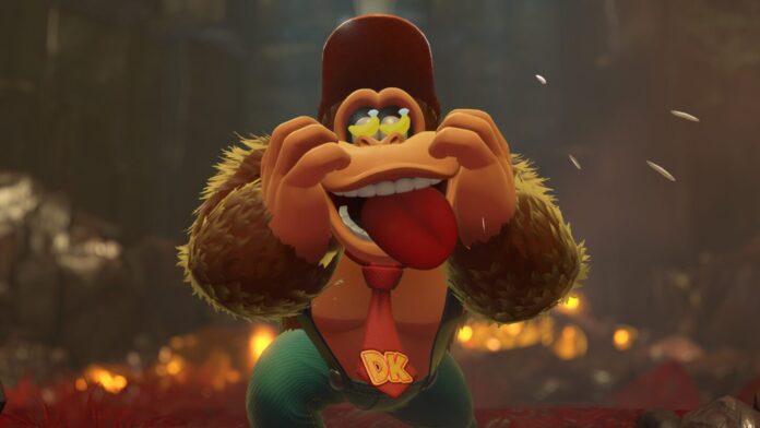 Donkey Kong ทำหน้าทะเล้นแลบลิ้นพร้อมดึงหน้าตัวเองในฉากหลังป่าที่เต็มไปด้วยแสงไฟ