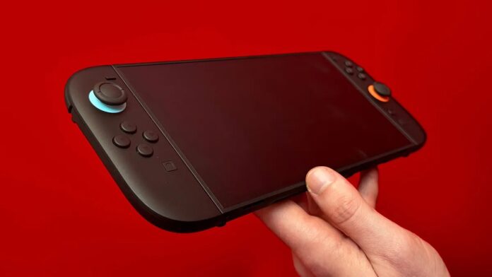 เครื่องเกม Nintendo Switch 2 สีดำ ดีไซน์ใหม่ ปุ่มอนาล็อกซ้าย–ขวาแต่งขอบสีฟ้าและส้ม พื้นหลังสีแดง