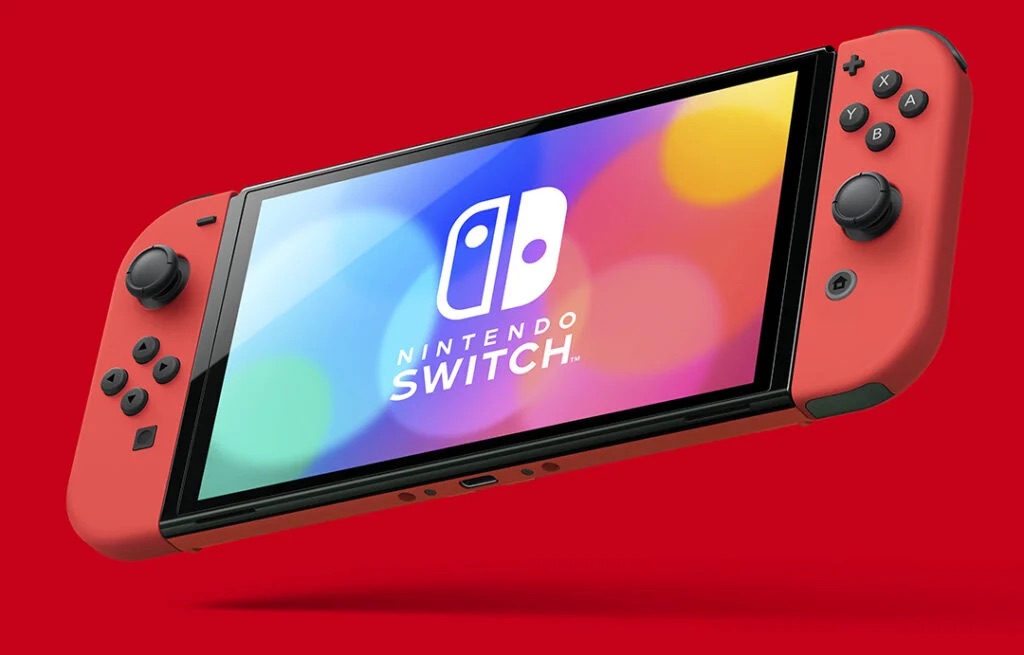 เครื่องเล่น Nintendo Switch OLED รุ่นสีแดง Mario Edition วางลอยอยู่บนพื้นหลังสีแดง พร้อมหน้าจอแสดงโลโก้ Nintendo Switch