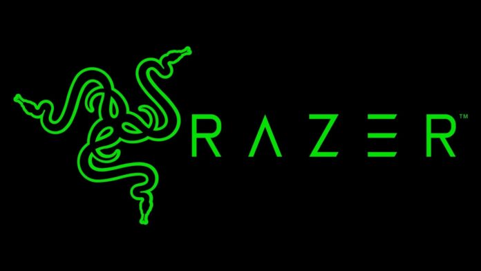 โลโก้ Razer สีเขียวบนพื้นหลังสีดำ สื่อถึงแบรนด์อุปกรณ์เกมมิ่งและเทคโนโลยีจาก Razer