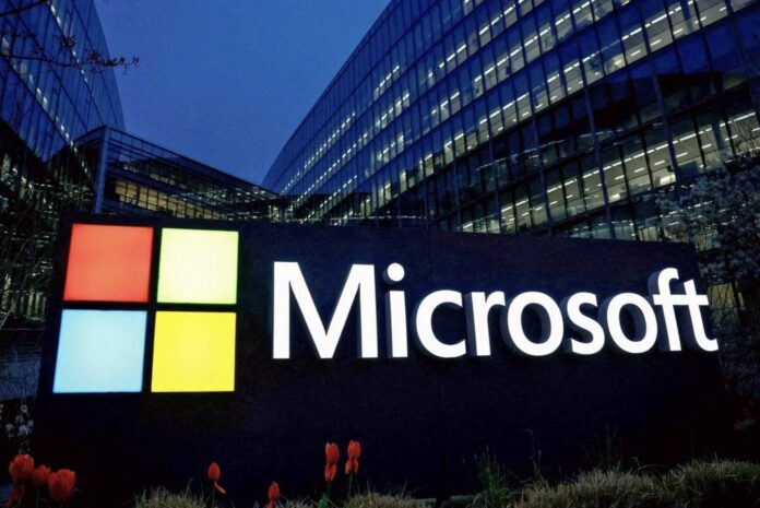 ป้ายโลโก้ Microsoft ด้านหน้าอาคารสำนักงานในช่วงกลางคืน