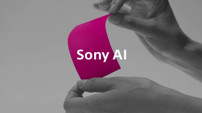 มือกำลังถือกระดาษสีชมพูที่มีข้อความ “Sony AI” บนพื้นหลังโทนขาวดำ