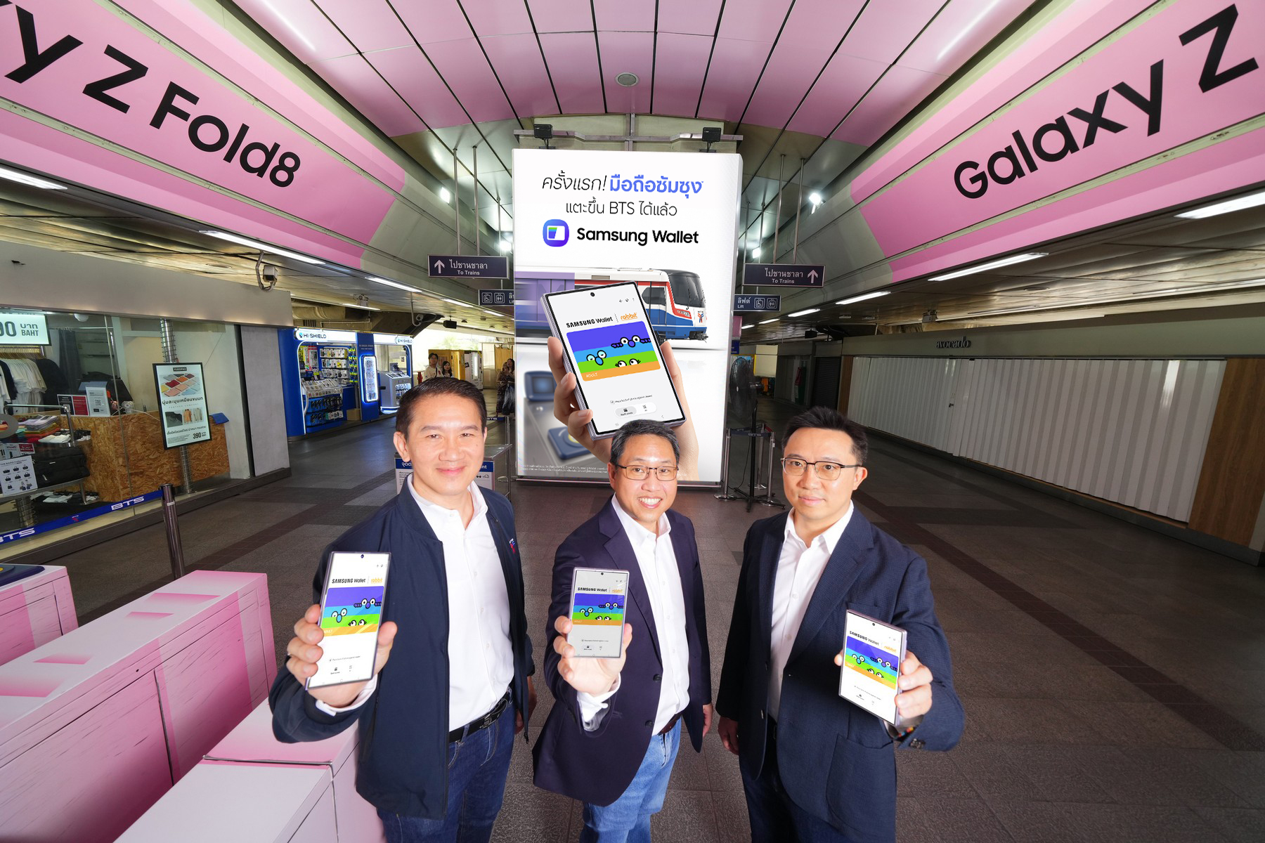 ผู้บริหารจากซัมซุง บีทีเอส และบัตรแรบบิท ถือสมาร์ทโฟนแสดงบัตรโดยสารในสถานีรถไฟฟ้า